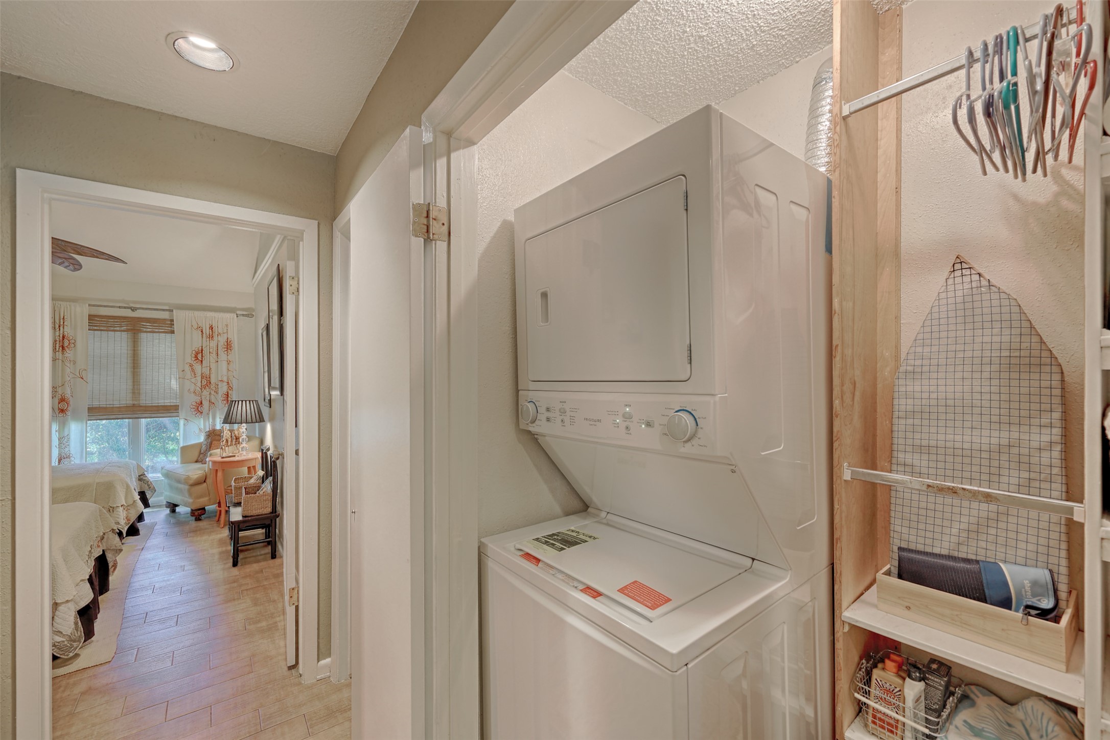 34 April Hill Conroe, TX 77356 - Photo 14 of 33 A double door closet with stacking washer, dryer and extra storage space is conveniently located near the bedrooms.