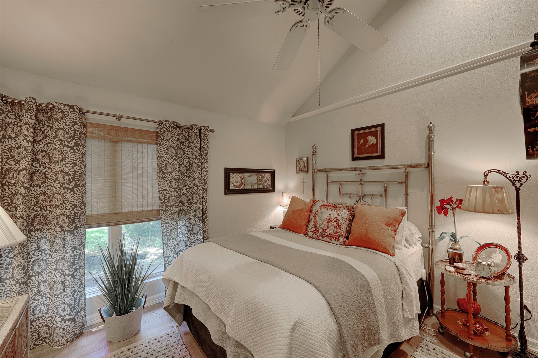 34 April Hill Conroe, TX 77356 - Photo 15 of 33 The primary bedroom is bright with large window overlooking the front yard and vaulted ceiling creates an airy feel.