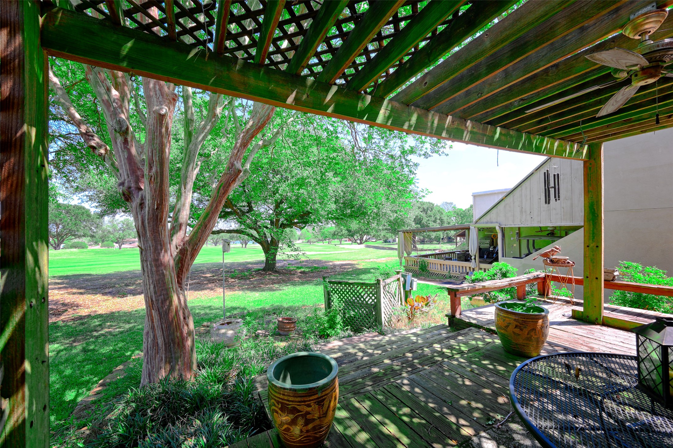 34 April Hill Conroe, TX 77356 - Photo 22 of 33 A deck area with pergola is the perfect spot to enjoy the outdoor views at this home.