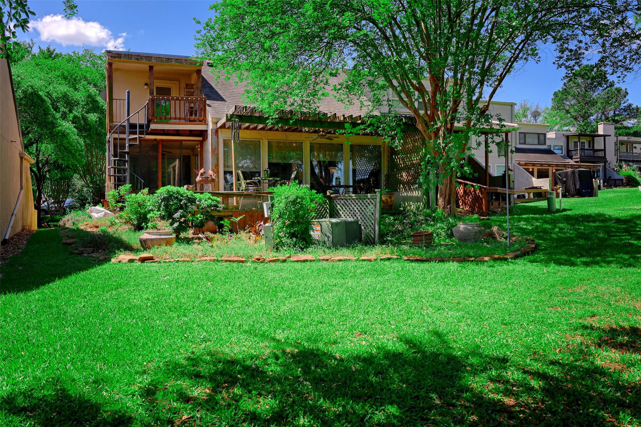 34 April Hill Conroe, TX 77356 - Photo 23 of 33 Back view of the home with mature trees for a shaded deck area.