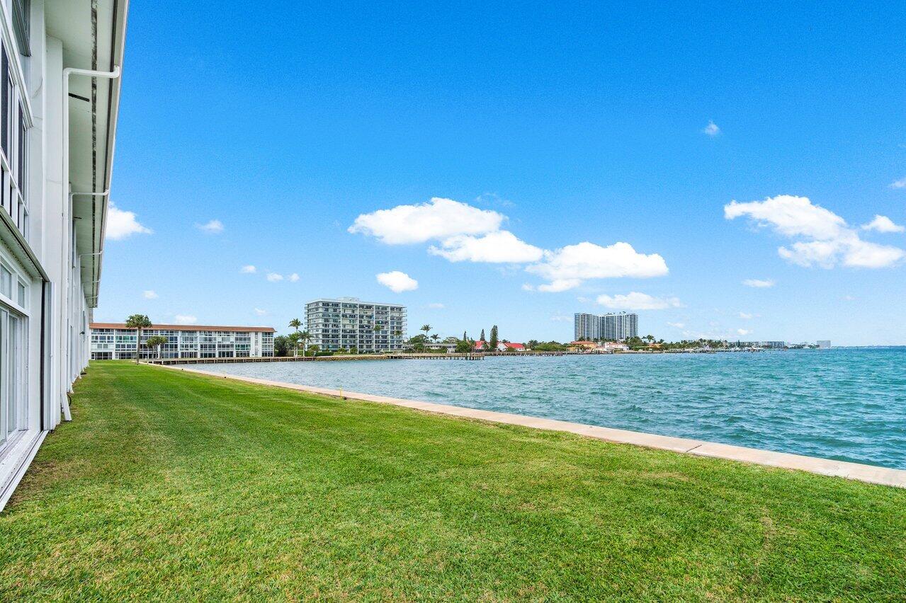 400 Wilma Circle, Unit 208 Riviera Beach, FL 33404 - Photo 14 of 28 a view of a house with a big yard and a large tree
