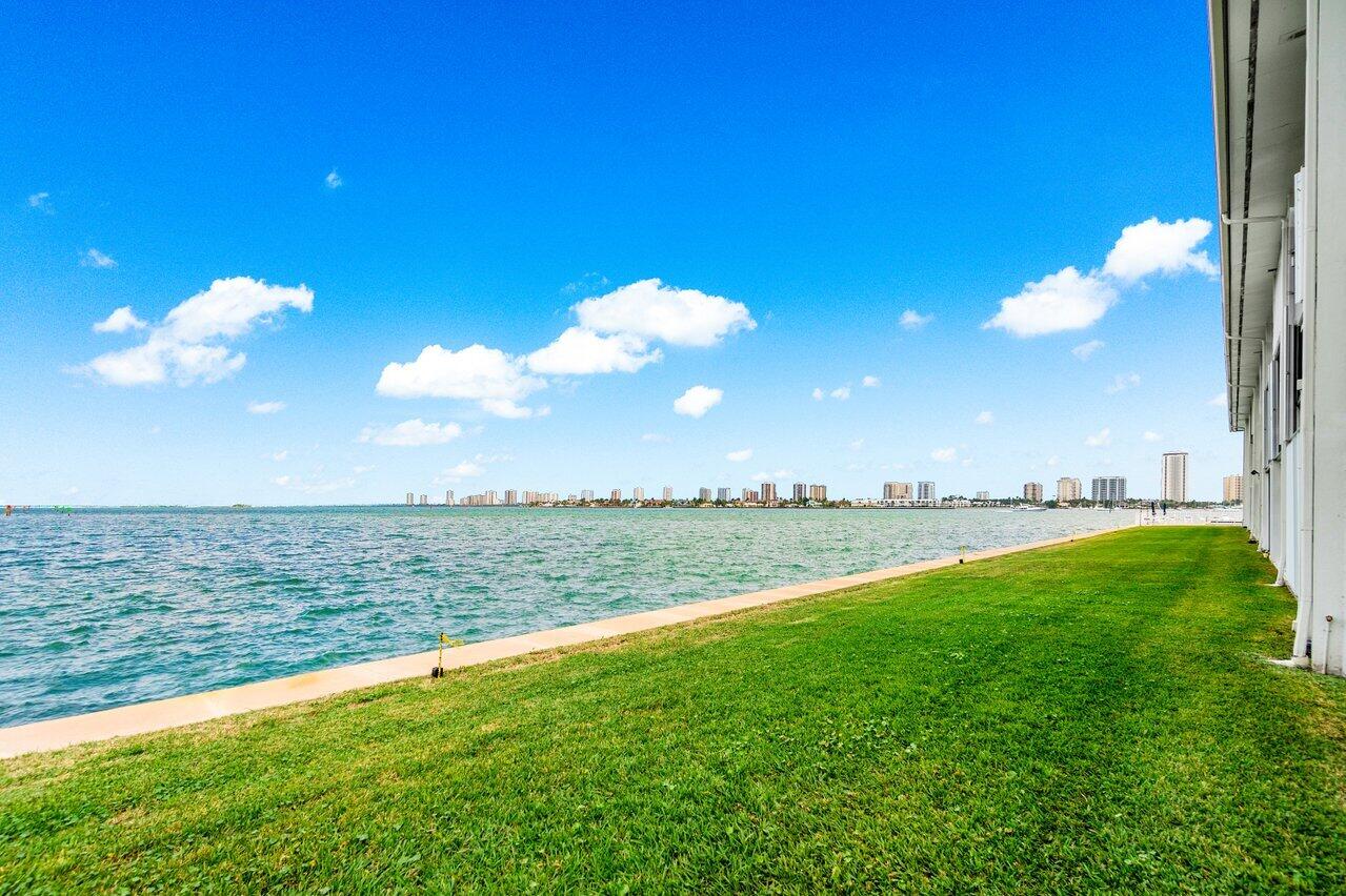 400 Wilma Circle, Unit 208 Riviera Beach, FL 33404 - Photo 15 of 28 a view of a lake with a yard