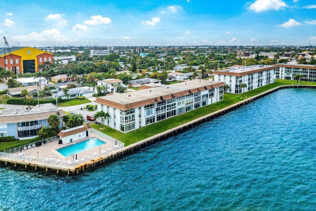 400 Wilma Circle, Unit 208 Riviera Beach, FL 33404 - Photo 24 of 28 an aerial view of a house with a garden and swimming pool