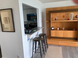 400 Wilma Circle, Unit 208 Riviera Beach, FL 33404 - Photo 7 of 28 a living room with furniture and a flat screen tv