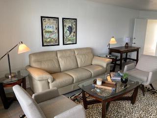 400 Wilma Circle, Unit 208 Riviera Beach, FL 33404 - Photo 9 of 28 a living room with furniture and a potted plant