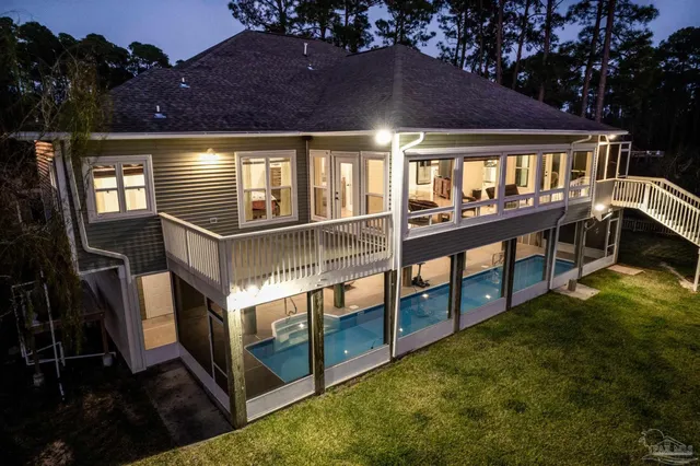 a kitchen with stainless steel appliances kitchen island granite countertop a stove a sink a refrigerator and white cabinets with wooden floor