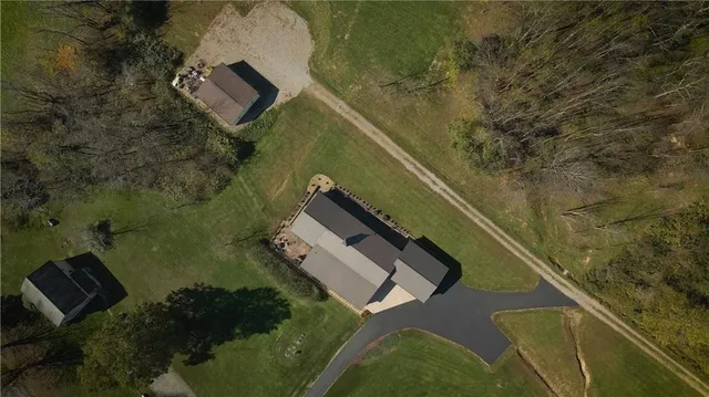 an aerial view of house with yard