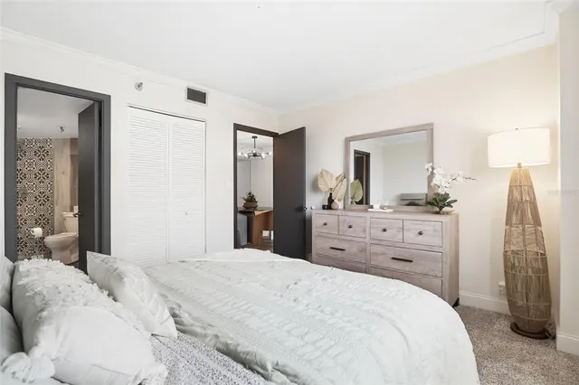 a bedroom with a bed and a mirror