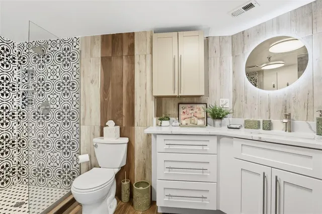 a bathroom with a toilet a sink and a mirror