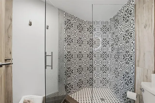 a bathroom with a shower toilet and a shower