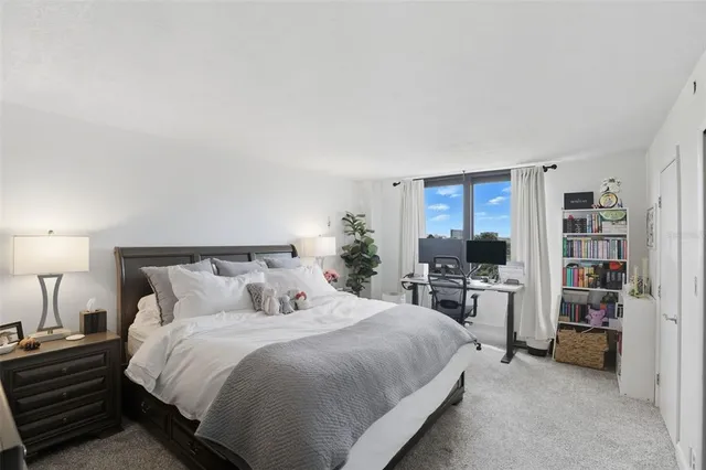 a bedroom with a bed and a couch