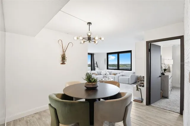 a dining room with furniture and wooden floor