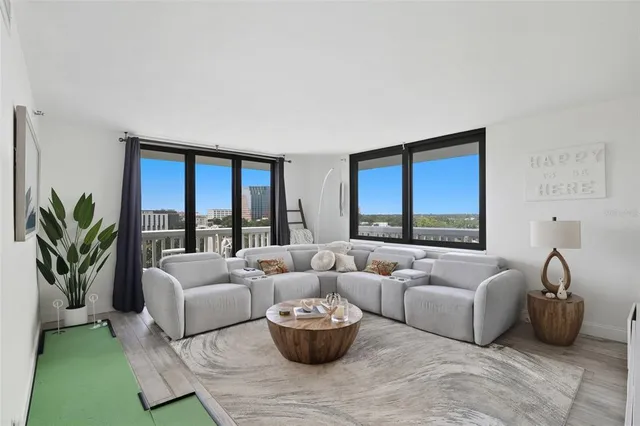 a living room with furniture and a potted plant