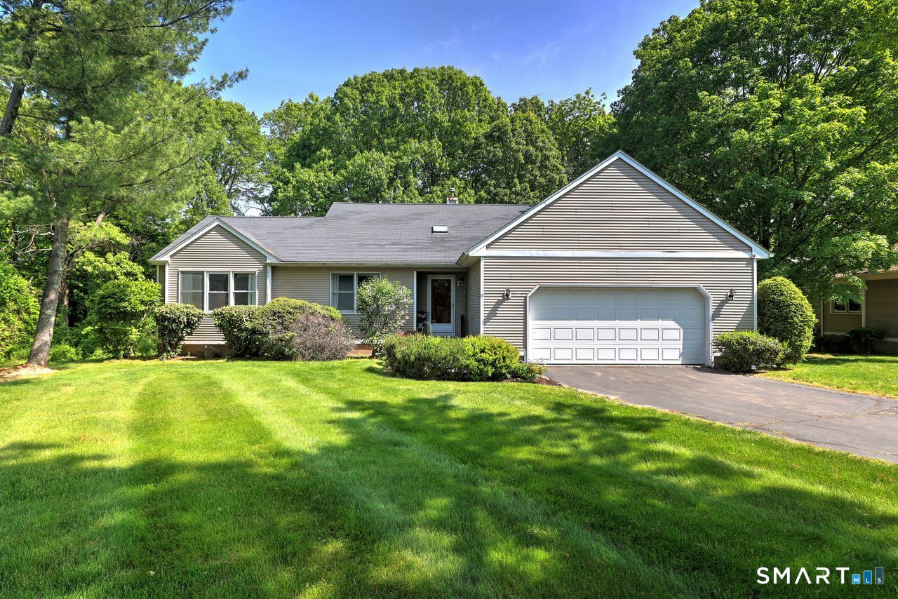 9 Canterbury Road, Unit 9 Hamden, CT 06514 - Photo 2 of 29 a front view of a house with a yard and garage
