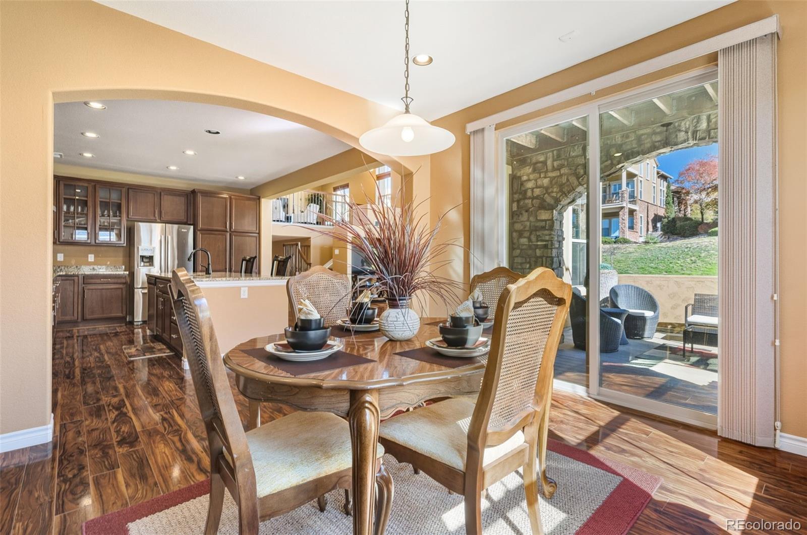 9472 Sori Lane Highlands Ranch, CO 80126 - Photo 11 of 43 a dining room with furniture a chandelier and wooden floor