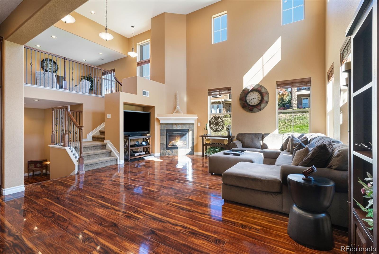 9472 Sori Lane Highlands Ranch, CO 80126 - Photo 2 of 43 a living room with fireplace furniture and a wooden floor