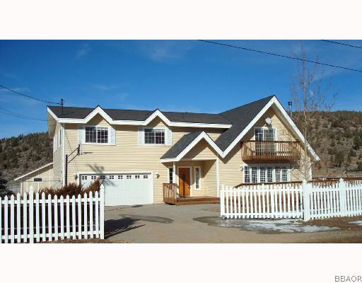 2125 Erwin Ranch Road Big Bear City, CA 92314 - Photo 1 of 8 a view of a house with a small yard and wooden fence