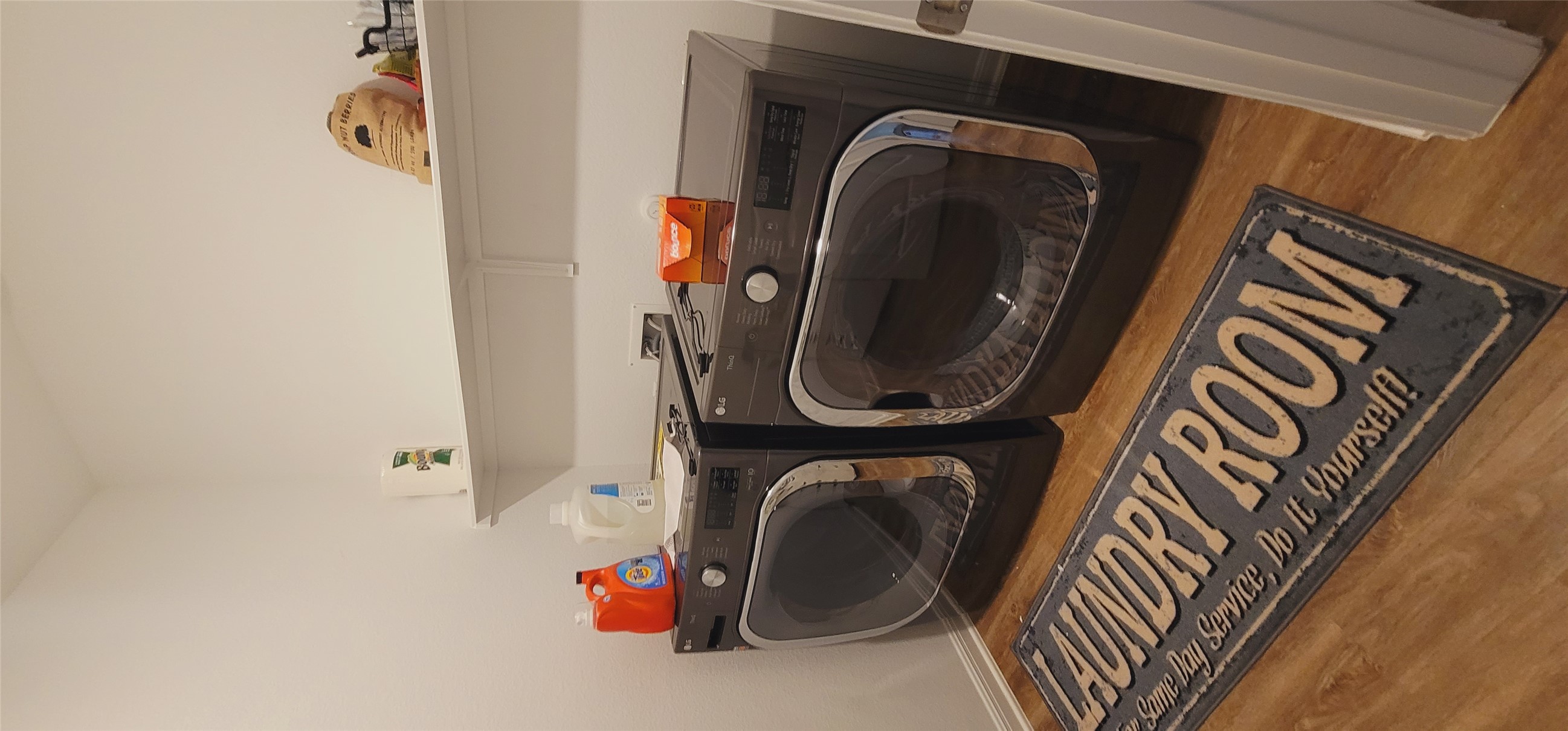 716 Leeward Pass Leander, TX 78641 - Photo 18 of 26 A well-equipped laundry room with convenient shelving and durable wood flooring.