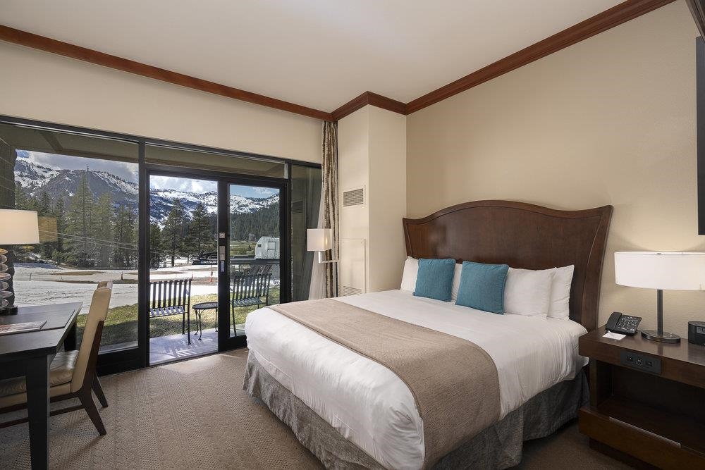 400 Resort Road, Unit 102104106 Olympic Valley, CA 96146 - Photo 11 of 27 a bedroom with a bed and a large window with outer view