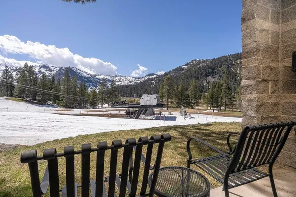 a view of swimming pool with lawn chairs and dinning table