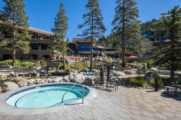 a view of a swimming pool with outdoor seating