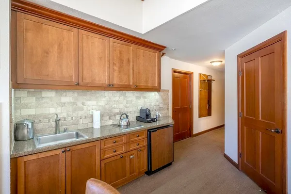 a kitchen with stainless steel appliances granite countertop wooden cabinets and sink