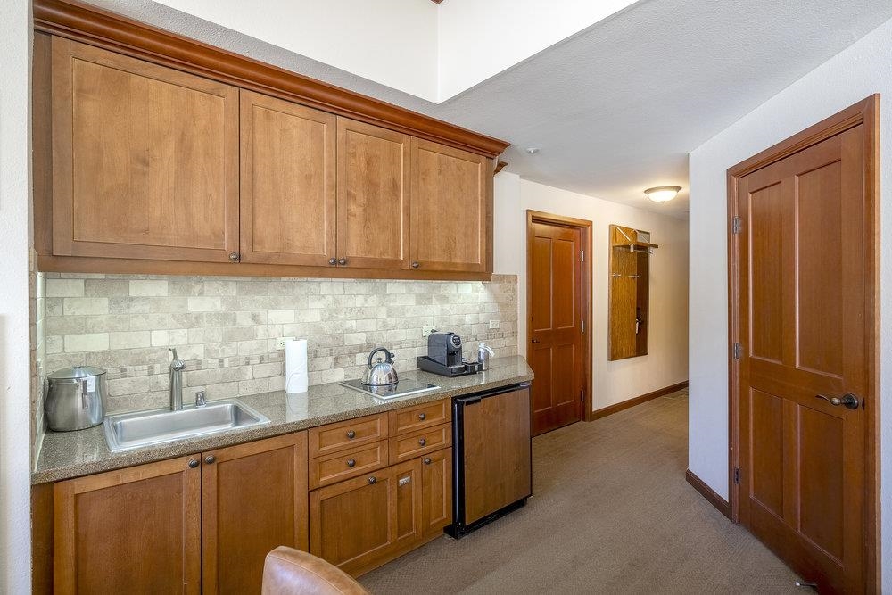 400 Resort Road, Unit 102104106 Olympic Valley, CA 96146 - Photo 7 of 27 a kitchen with stainless steel appliances granite countertop wooden cabinets and sink