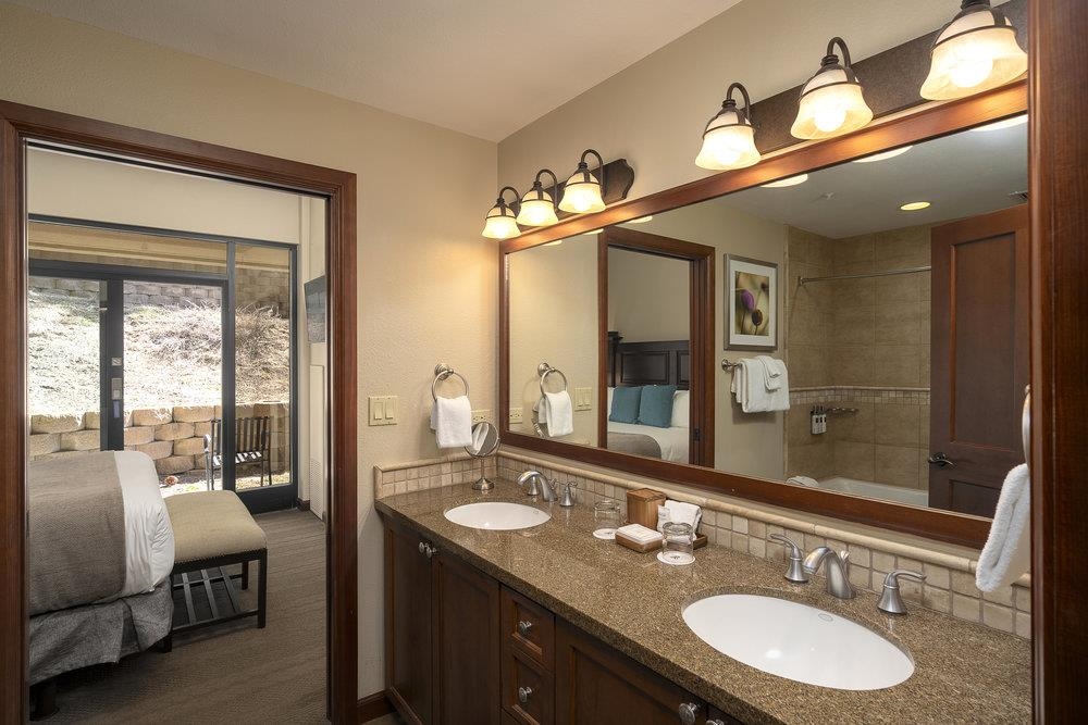 400 Resort Road, Unit 102104106 Olympic Valley, CA 96146 - Photo 8 of 27 a bathroom with a granite countertop double vanity and a mirror