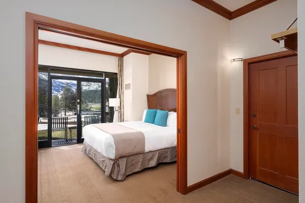 a bedroom with a large bed and a large window