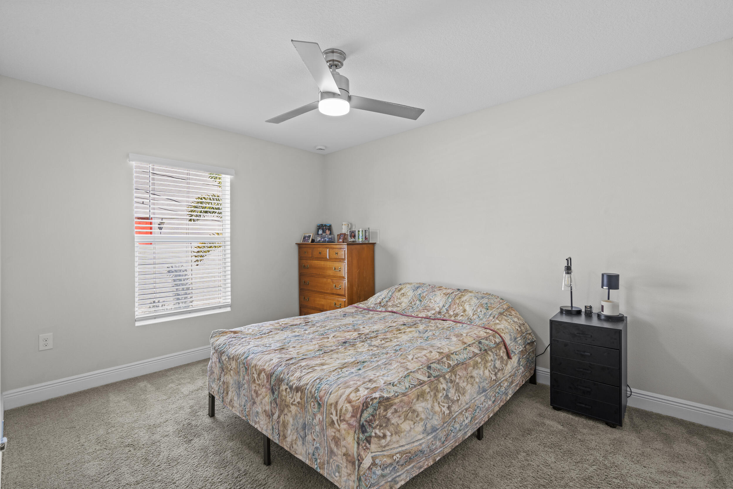 643 Southwest Curry Street Port St. Lucie, FL 34983 - Photo 12 of 21 a bedroom with a bed and a window