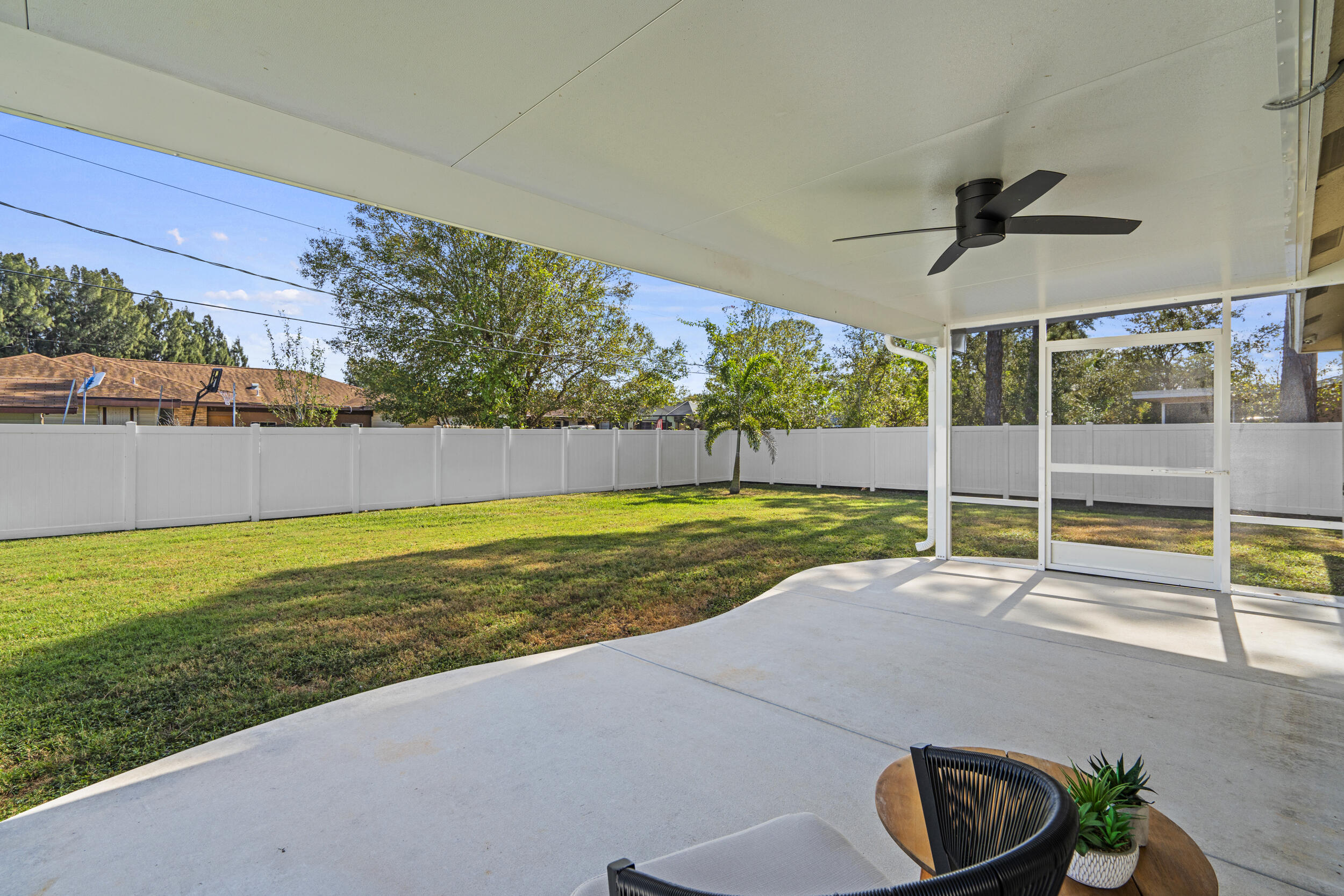 643 Southwest Curry Street Port St. Lucie, FL 34983 - Photo 16 of 21 a view of a swimming pool with an outdoor seating and a yard