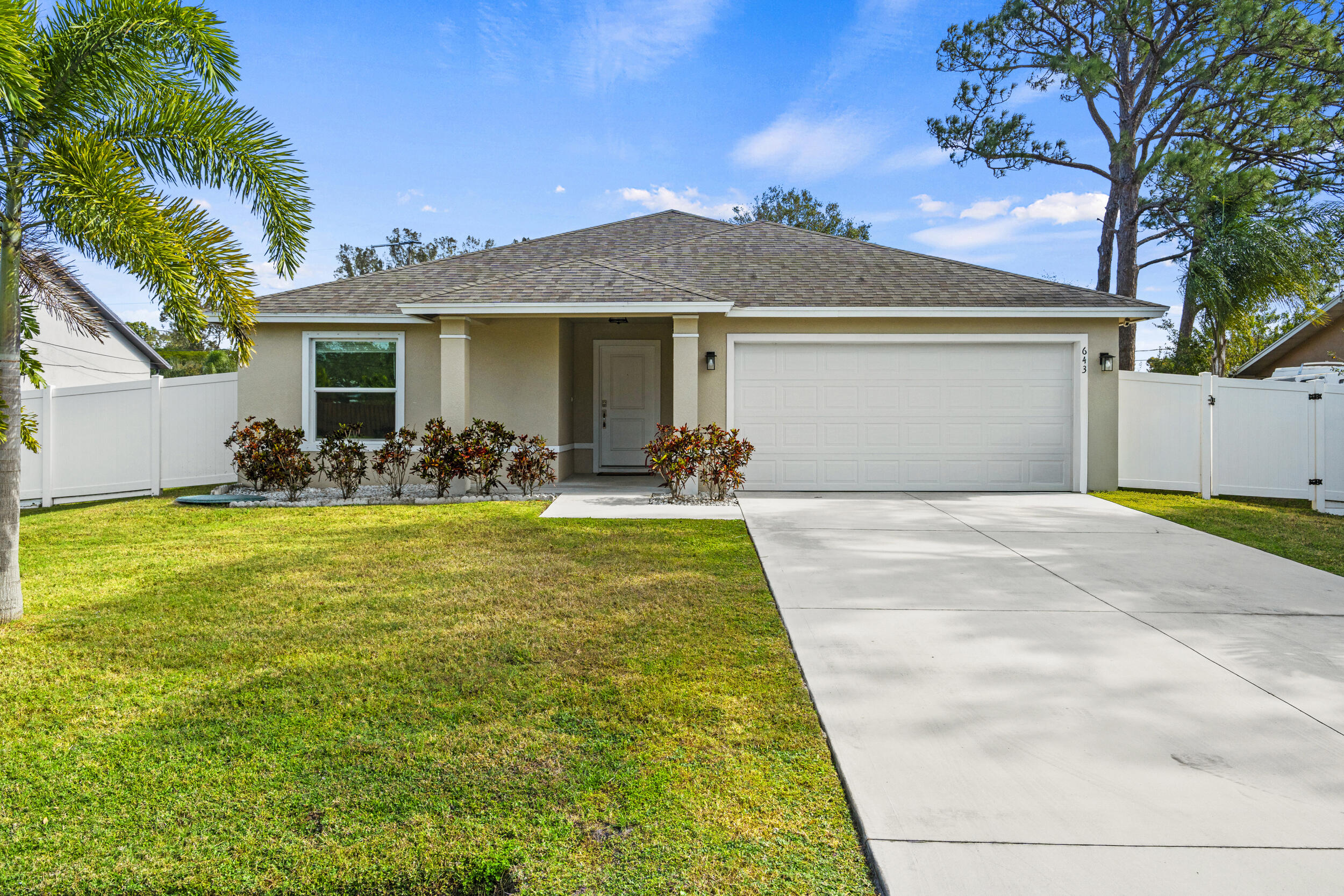 643 Southwest Curry Street Port St. Lucie, FL 34983 - Photo 2 of 21 a front view of house with yard