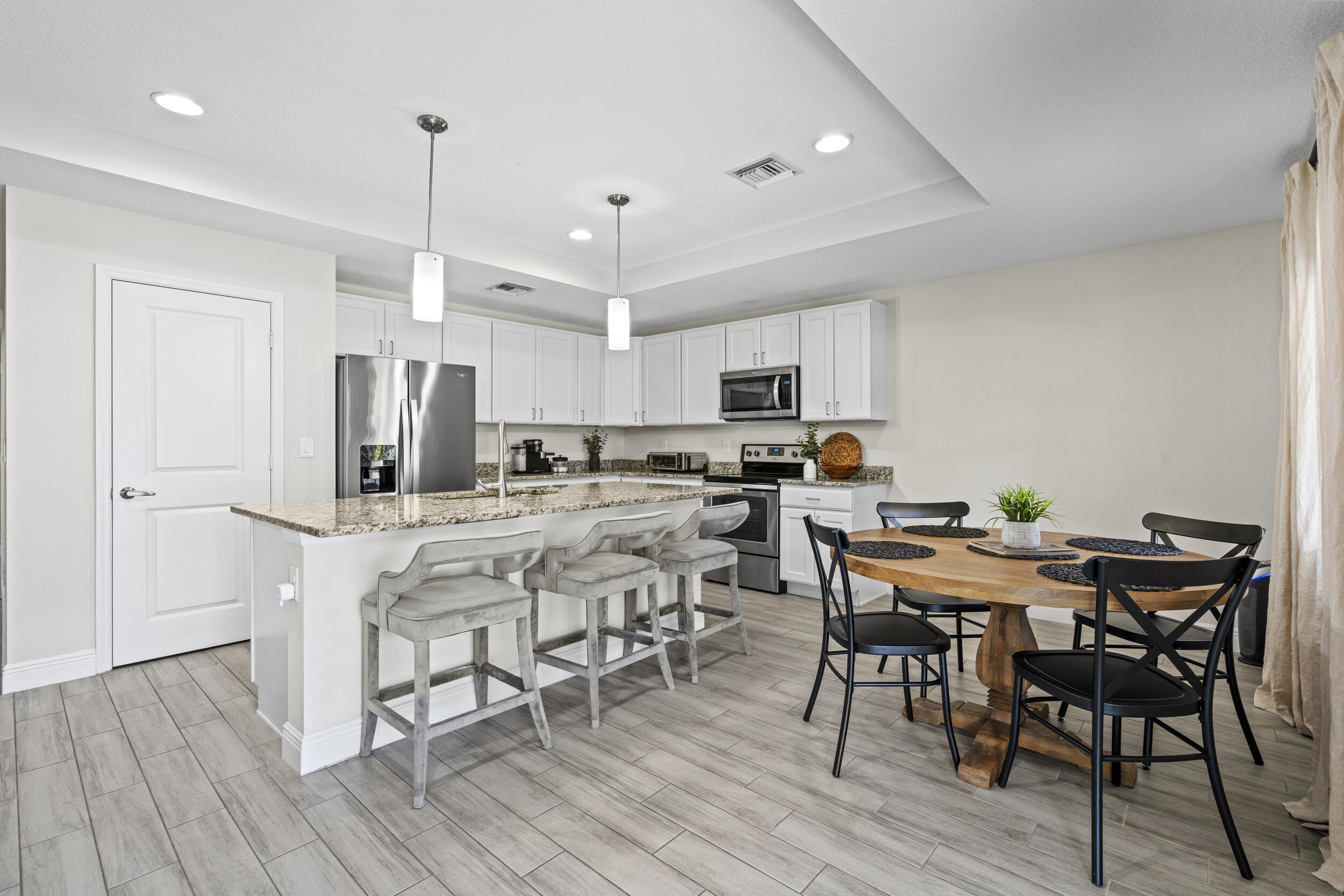 643 Southwest Curry Street Port St. Lucie, FL 34983 - Photo 6 of 21 a view of a dining room with furniture and wooden floor