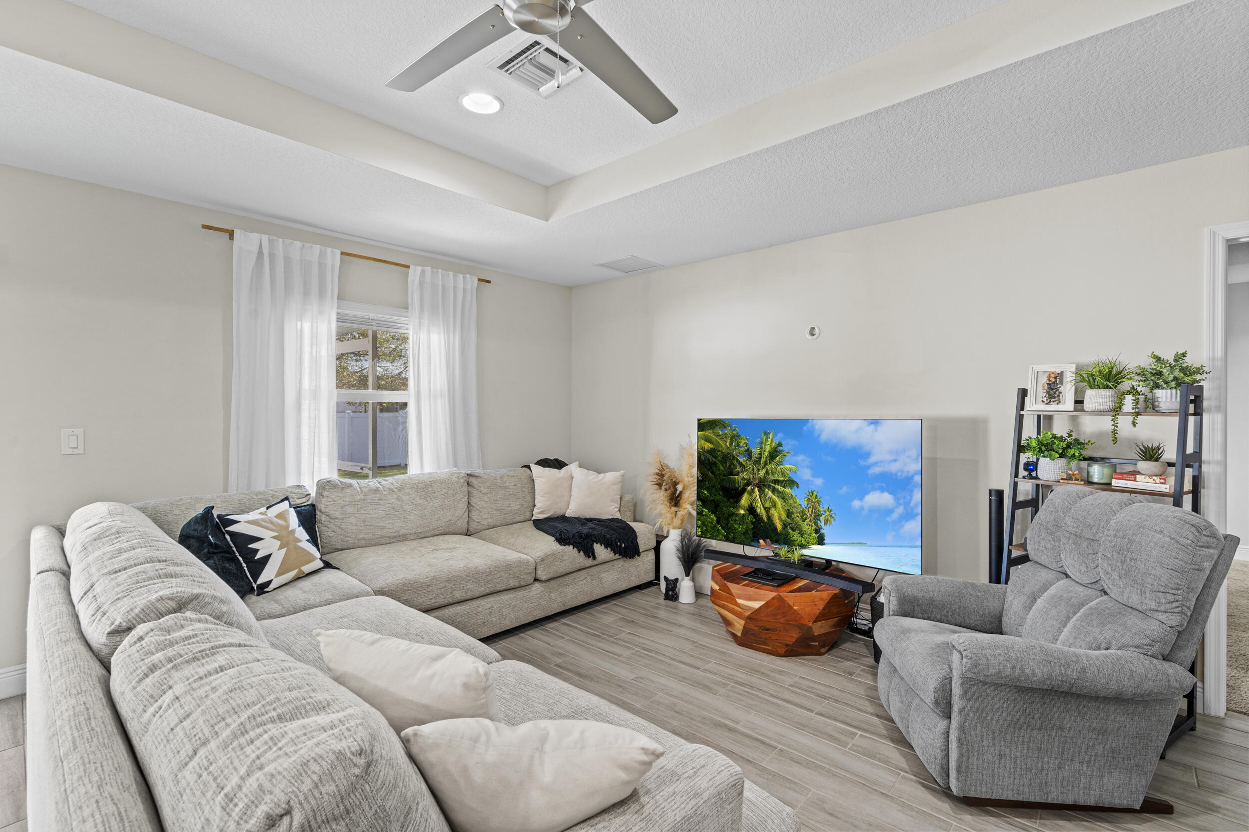 643 Southwest Curry Street Port St. Lucie, FL 34983 - Photo 8 of 21 a living room with furniture and a flat screen tv