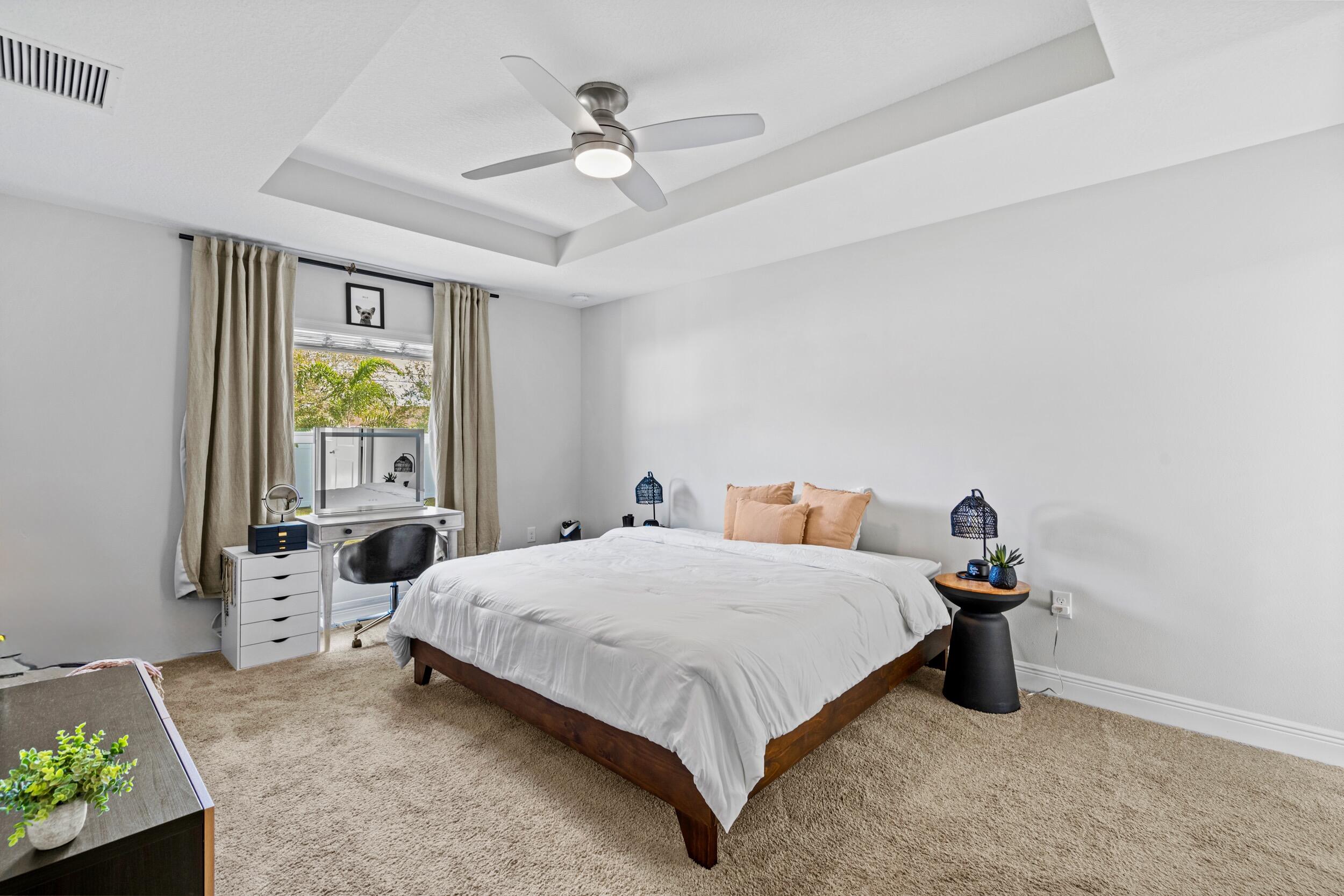 643 Southwest Curry Street Port St. Lucie, FL 34983 - Photo 9 of 21 a bedroom with a bed and a window