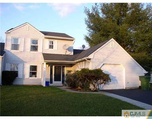 46 Woodbury Road Edison, NJ 08820 - Photo 1 of 18 a view of a yard in front of a house with plants and large tree