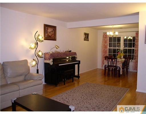 46 Woodbury Road Edison, NJ 08820 - Photo 3 of 18 a living room with furniture and a piano