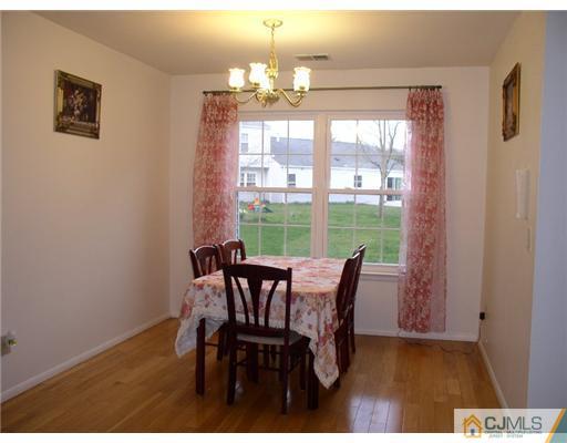 46 Woodbury Road Edison, NJ 08820 - Photo 4 of 18 a view of a dining room with furniture wooden floor and chandelier