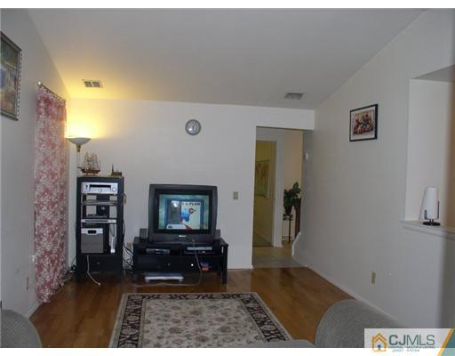 46 Woodbury Road Edison, NJ 08820 - Photo 7 of 18 a room with furniture and a rug