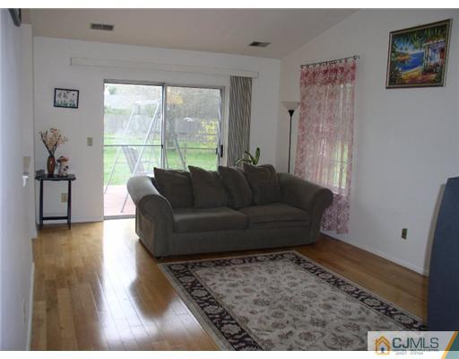 46 Woodbury Road Edison, NJ 08820 - Photo 8 of 18 a living room with furniture and a rug