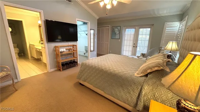 a bedroom with a bed and a flat tv screen on wall