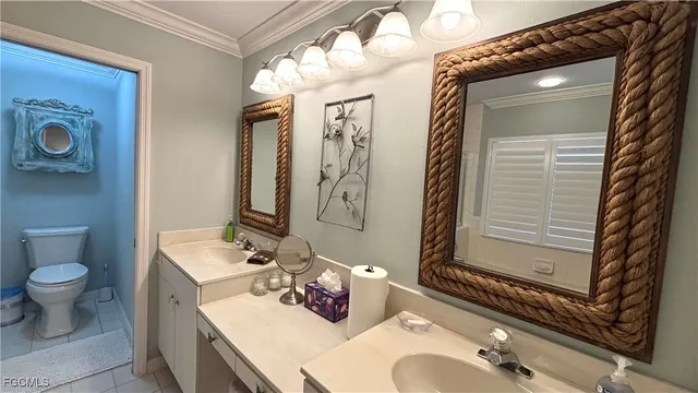 a bathroom with a sink vanity mirror and toilet