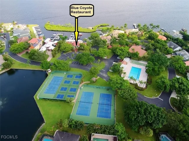 a green field with flowers and trees
