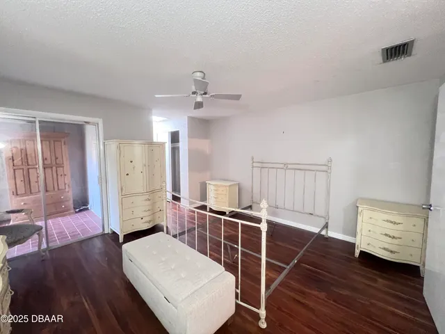 a view of a kitchen with furniture and wooden floor