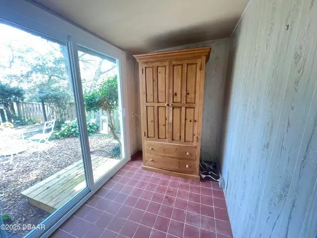 a view of empty room with wooden floor and windows