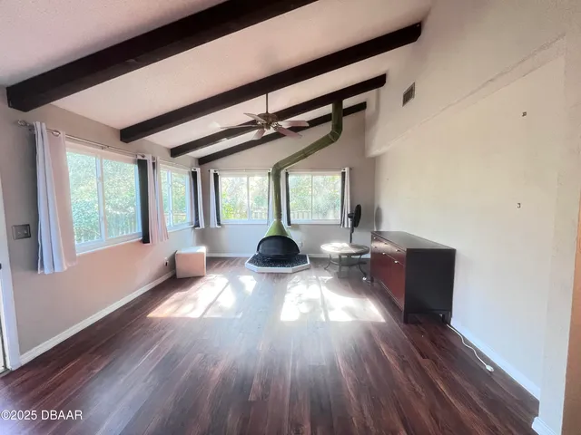 a view of living room and dining room with wooden floor