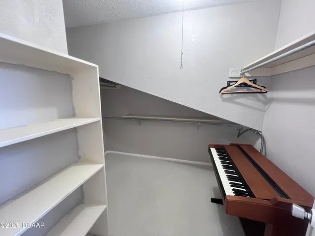 a view of an empty room with stairs