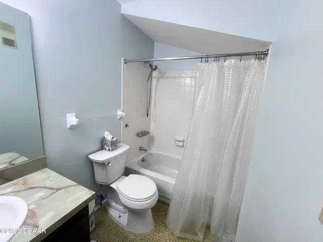 a white toilet sitting next to a bathroom sink