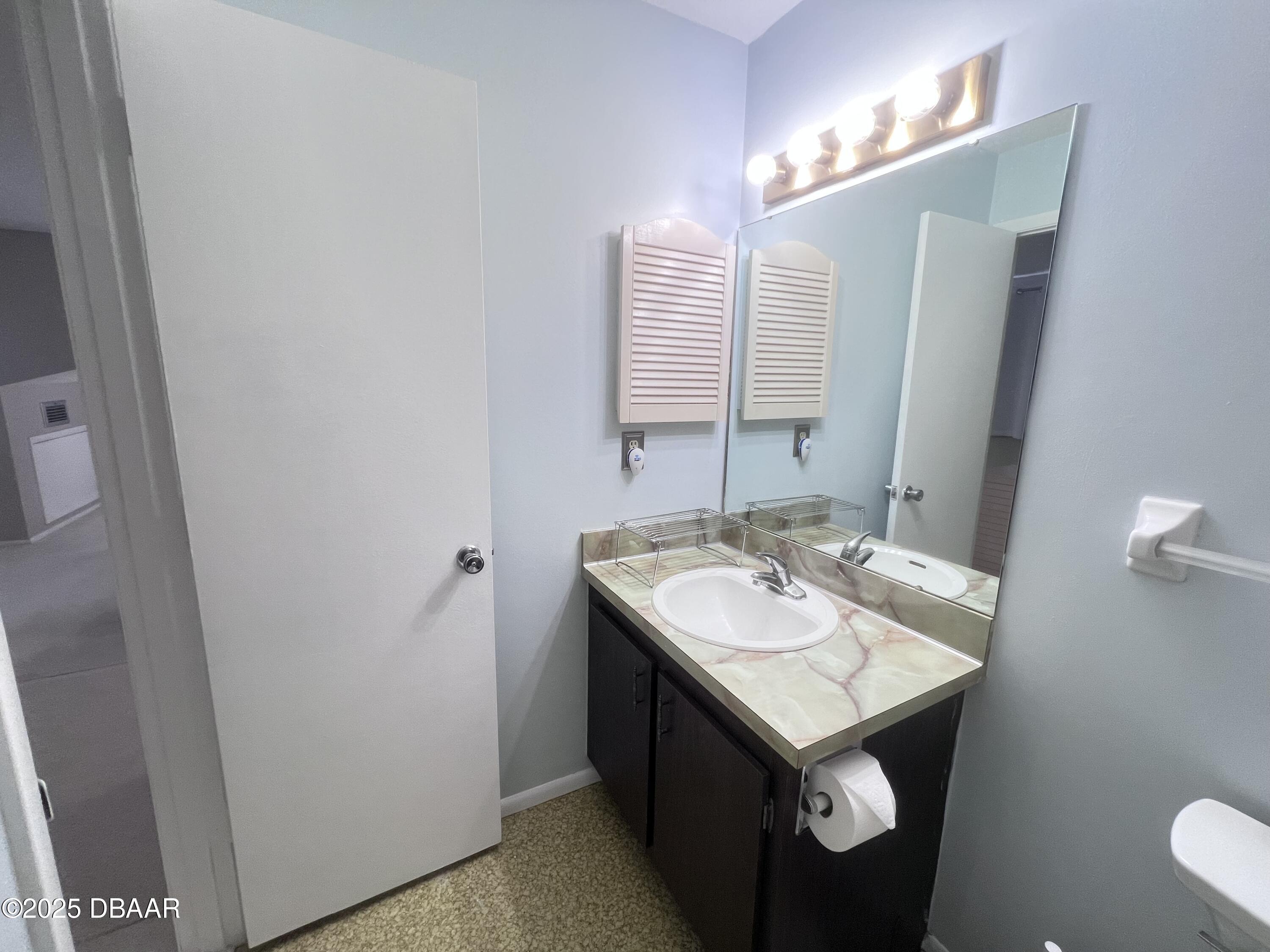 80 Cypress Pond Road Port Orange, FL 32128 - Photo 25 of 31 a bathroom with a sink and a mirror