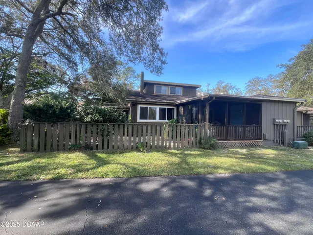 a view of a house with swimming pool and a yard